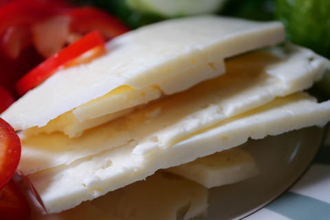 Cheese and vegetable slices on a plate in the kitchen