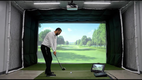 premium indoor golf simulator, back view, enormous projected golf course on impact screen