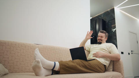 Successful freelancer celebrating project completion on sofa
