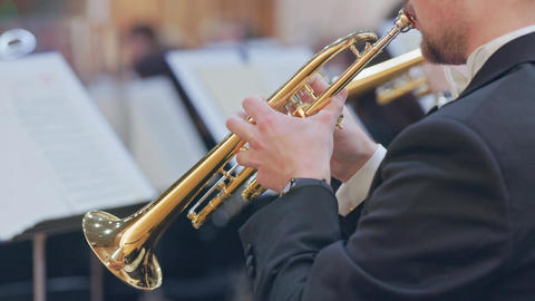 Musician playing trumpet in a classical orchestra concert