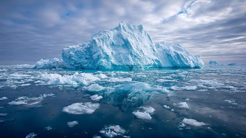 Iceberg floating in arctic ocean showing glacier melt