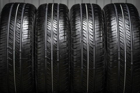 A stack of new rubber car tires