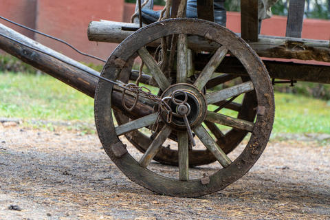 Antique wooden wagon wheel with iron rim