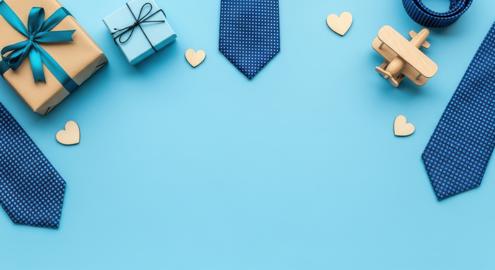 Father's day gifts and accessories with wooden airplane on blue background