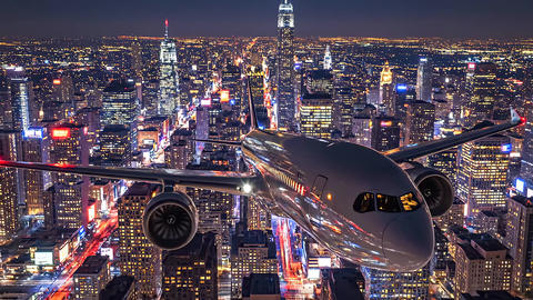 Front view of passenger airplane departing illuminated megapolis at night, powerful ascent over