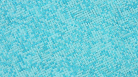 background of blue small tiles at a swimming pool as harmonic background. Summer