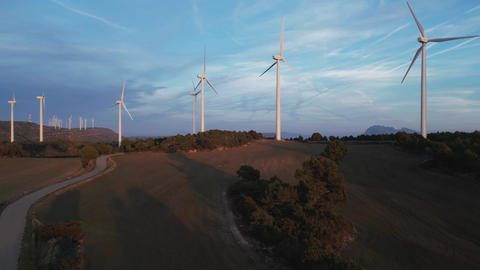 Aerial view of wind turbines generating clean energy at sunset