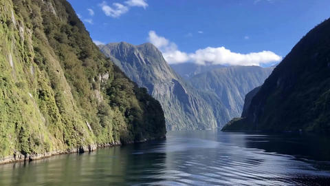 Scenic View Of Green Mountains And Blue Fjord Water