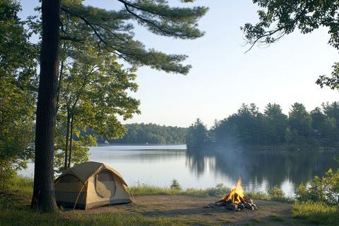 Serene Lakeside Camping Scene with Tent Set Against Tranquil Water and Forest Views