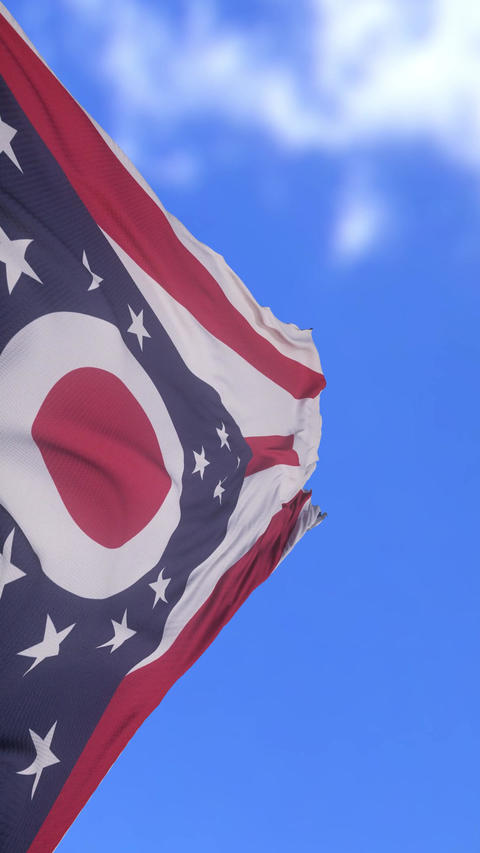 Close Up of Ohio State Flag Waving Against Bright Blue Sky