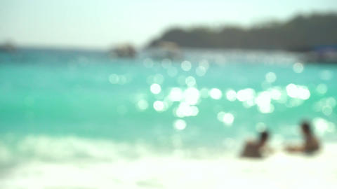 Tropical Beach with People Enjoying the Sea