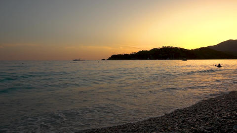 Tropical Evening Sunset with Swimmers in the Sea