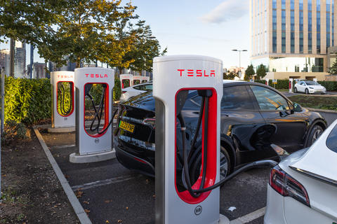 Tesla electric vehicles charging at a Supercharger station. London, UK, 14 October 2023