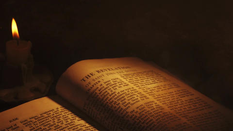 Revelations prophecy in Bible with smoke in candlelight