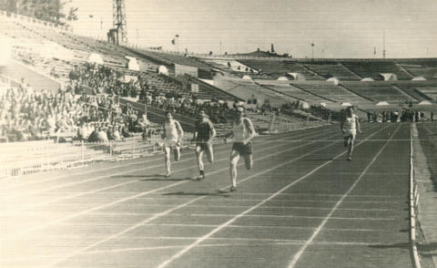 Vintage athletic track race at soviet stadium with crowd 1960s