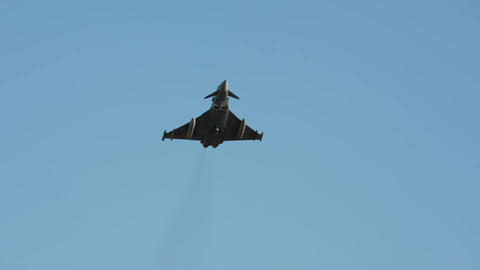 Military fighter jet banking turn in clear sky slow motion