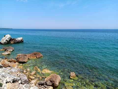 Aegean Sea with diagonal rocky shoreline and pebbles