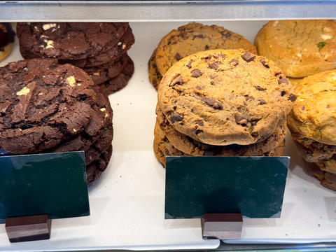 Chocolate cookies stack and bakery biscuits in showcase. Sweet snack, dessert selection, sugar