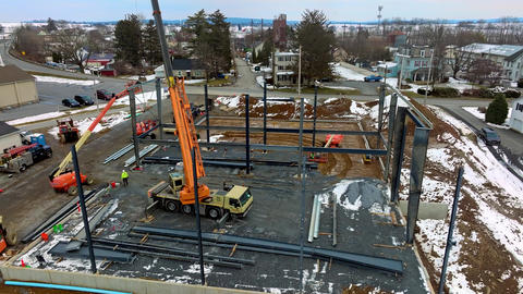 Construction of New Building in Winter With Cranes and Machinery at Work in the