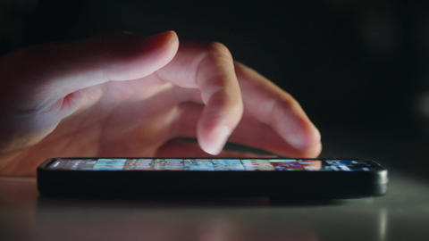 Smartphone social media scrolling by male hand shows modern digital lifestyle