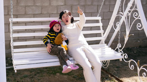 The babysitter spends time with the baby. An enthusiastic mother and daughter saw something in the
