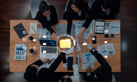 Business team collaborating on project analysis at modern office table with