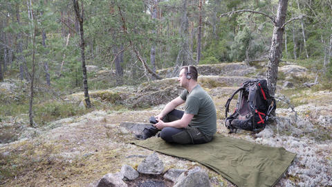 Hiker Relaxing on Camping Mat in Forest