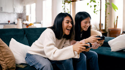 Friends enjoying fun video game competition at home