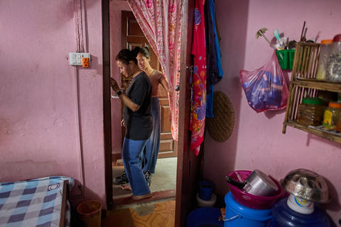 Two Individuals Sharing a Moment in a Cozy Room Decorated with Colorful Fabrics