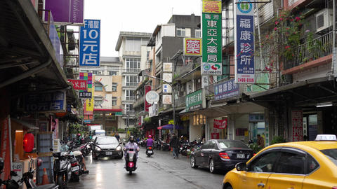 Motorcycles Passing on a Rainy Road in Ruifang, Taiwan