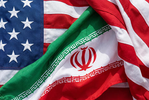 Close up of overlapping american and iranian flags fluttering