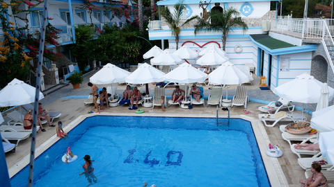 Swimming pool with sun loungers next to it in the hotel