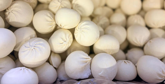 Frozen khinkali in supermarket freezer display background