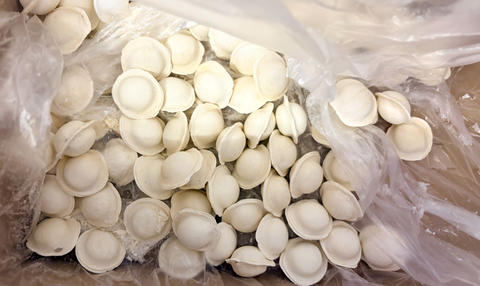 Frozen dumplings in supermarket freezer display close up