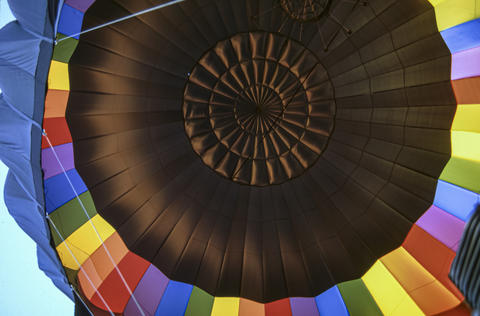 Hot Air Balloon Seen From Below During Launch in Bright Colors and Sunlight