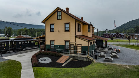 Train Station Building With Outdoor Seating and Train Tracks in a Rural Area of