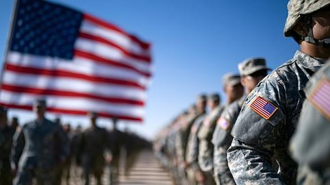 Us army soldiers standing in formation with american flag waving