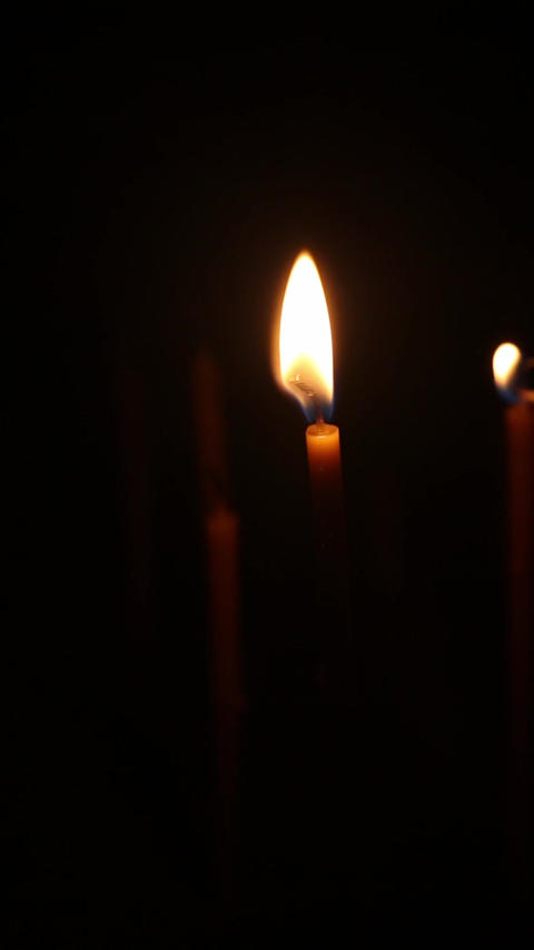 Lighting single church candle during religious prayer ritual