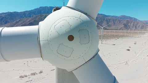 Extreme drone close up of wind turbine structure and blades in Palm Springs California desert