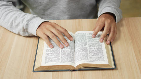 Person Reading the Bible and Praying in Quiet Devotion