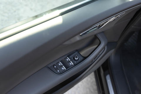 Window control buttons in modern luxury electric car. Door handle with power window control. Car
