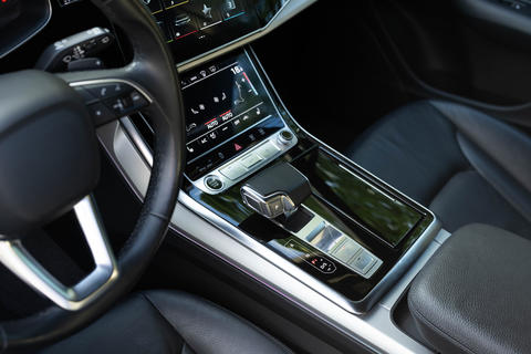 Close up of the automatic gearbox lever, black interior car. Automatic transmission gearshift stick