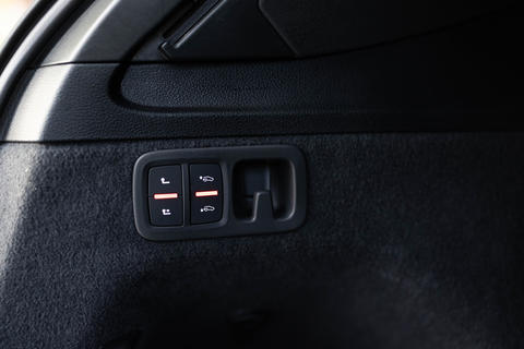 Buttons in the trunk for extending the towbar. Car tow hitch button or opening system. Button for
