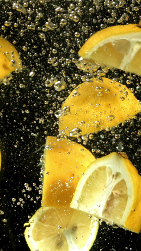 Lemon slices with air bubbles under water. Filmed on a high-speed camera at 1000