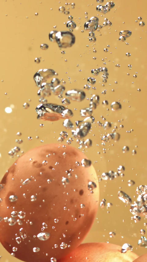 Eggs fall under water with bubbles. Filmed on a high-speed camera at 1000 fps