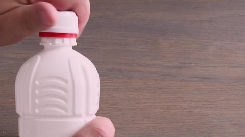 Forcefully open the safety lid on a container containing a chemical product