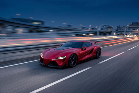 Red sports car speeding on highway at night with motion
