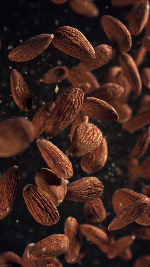 Almonds fly up and fall down. Filmed on a high-speed camera at 1000 fps