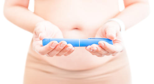 Woman holding GLP-1 weight loss injection pen isolated on light background