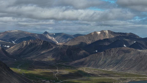 Top View establishing shot glide over mountain range and tundra valley Chukotka